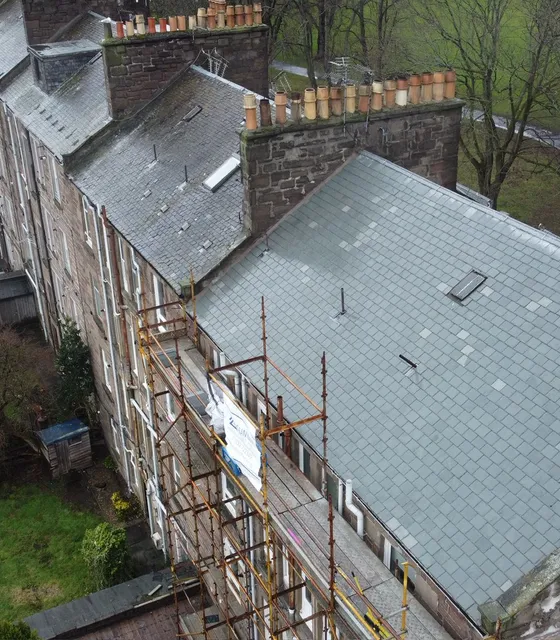 Aerial view of Dundee tenement rooftops with scaffolding during roof repairs