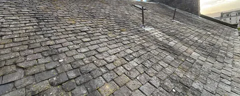 Weathered slate roof in Dundee before repair work