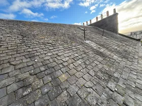 Weathered slate roof before repair