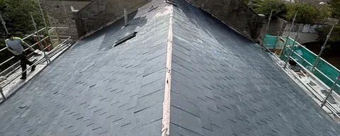 Slate roof ridge and chimney viewed during roof survey