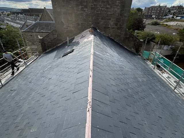 Completed slate roof with ridge tiles and chimney in Dundee